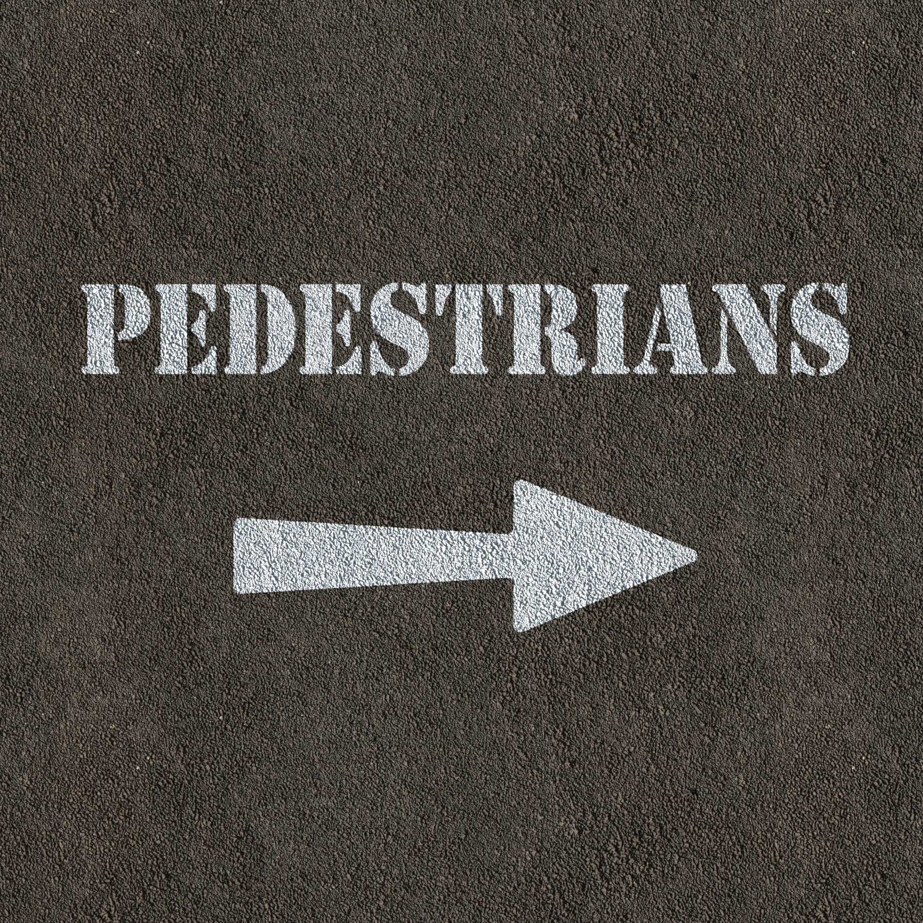 Pedestrians and arrow stencil painted on road